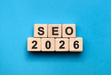 Seo New year 2026 concept. Wooden cubes on a blue background