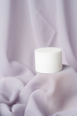 The soft gray background enhances the purity and elegance of the white packaging