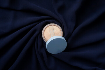 An open Wardah powder case rests gracefully on a navy-colored fabric