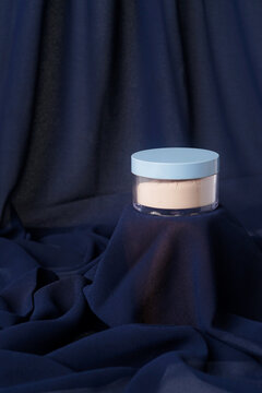 Soft lighting enhances the gentle texture of the fabric and the powder&rsquo;s smooth surface