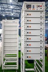 Modular energy storage system with white battery units in racks, symbolizing modern clean energy technology for sustainable power solutions and grid infrastructure, displayed in an industrial setting.