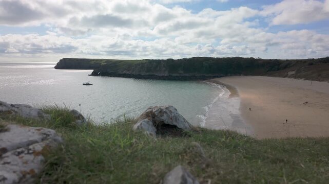 Summertime establishing shot of Barafundle Bay Beach on the Pembrokeshire coast, Wales.