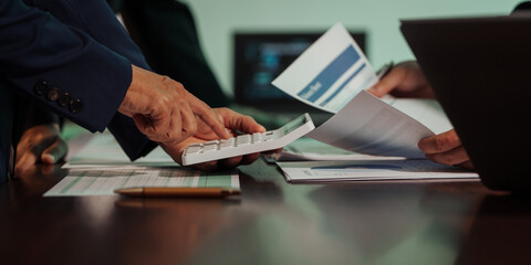 Business professionals closely review a balance sheet and digital Global Investment Portfolio data, pointing to key figures, indicating strategic financial planning and rigorous cash flow management.