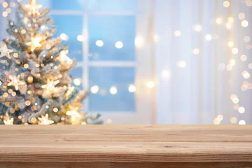 Fotobehang Beren Wooden table top for product display in front of blur Christmas tree and decorated window interior background  © didecs