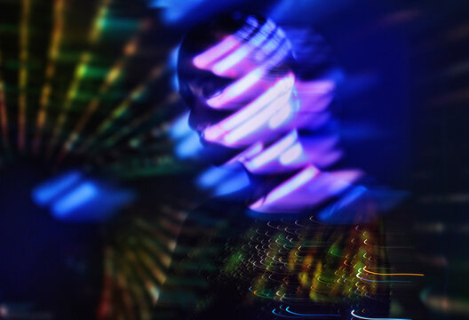 Surreal woman in neon blue light with cyberspace and virtual reality effect