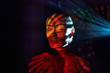 Surreal portrait with neon light effect and closed eyes in cyberspace