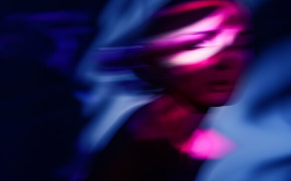 Surreal motion blur portrait with neon magenta and blue light fantasy