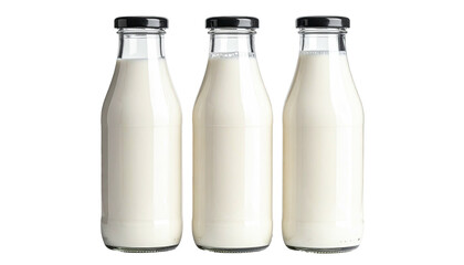 Three glass bottles filled with white liquid against dark background