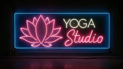 Yoga studio sign glowing in vibrant neon colors at night