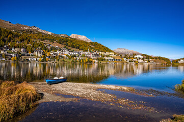 The village and lake of St. Moritz in autumn, with the trees turning color. Engadine, Switzerland.