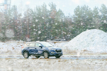 Car traveling on snow-covered road