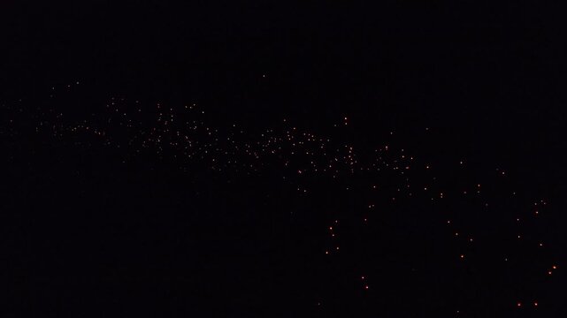Aerial view of the enchanting Parangtritis Lantern Festival illuminating the night sky with bright orange lanterns, Yogyakarta, Special Region of Yogyakarta, Indonesia.