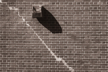 Old brick wall with diagonal cracks
