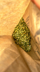 Split green peas inside an open paper sack