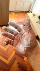 Hand covered in white paint during home project
