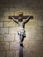 Crucifix sculpture mounted on stone church wall