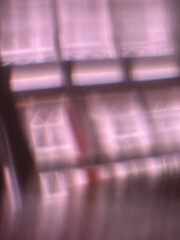 Blurred window grid casting soft reflections indoors