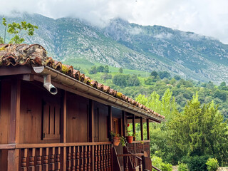 Rustic wooden balcony overlooking green mountain landscape