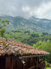 Rustic tiled roof overlooking misty green mountains