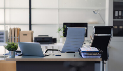workspace with desktop computer, office supplies, houseplant and coffee cup at office.