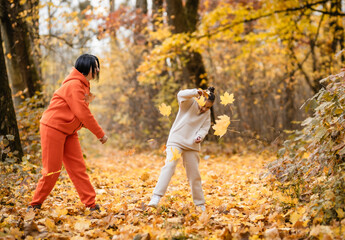 Fototapeta premium Family throw yellow autumn leaves.