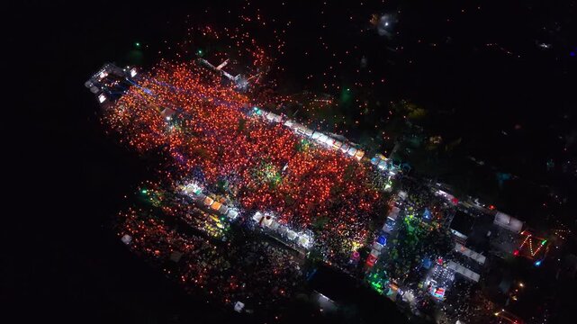 Aerial view of a vibrant Parangtritis Lantern Festival, where the warm glow of lanterns creates a mesmerizing spectacle against the dark sky, Yogyakarta, Special Region of Yogyakarta, Indonesia.