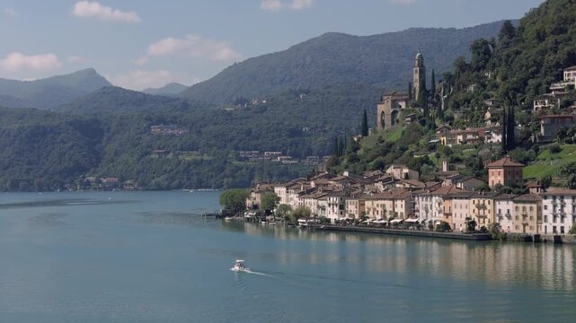 Small boat heading towards Morcote in Switzerland