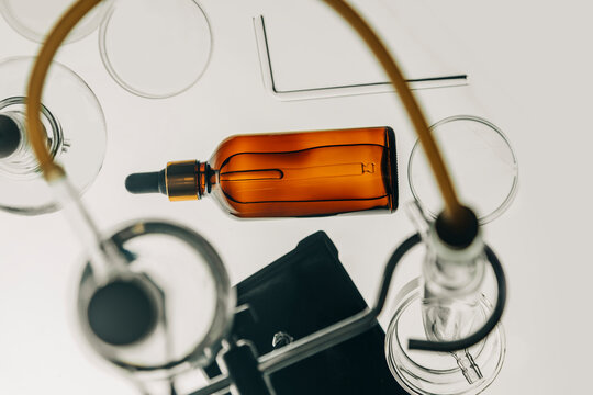 Amber glass bottle with dropper in a chemical laboratory setting for fragrance invention