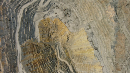 Aerial of open mine and heavy mining equipment