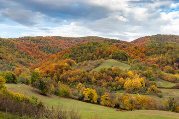 Vibrant autumn mountain landscape with colorful forests and fields