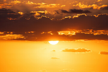 Golden Scenic Cloudscape and dramatic blue sky during beautiful sunrise over the sea