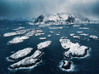 Aerial view over beautiful Henningsvaer Lofoten islands, Norway, winter landscape of snowing over small islands in sea water