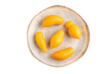Yellow tomatoes on plate isolated on white. Top view, close up