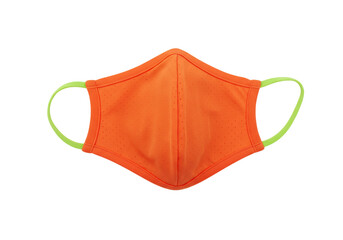 Isolated orange face mask with green trim, protective gear, safety during pandemic era