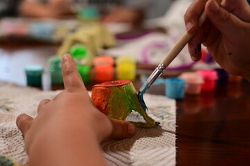 Close up view of child's hands painting