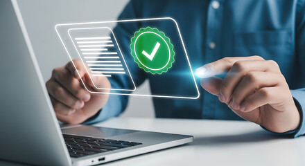 Person using a laptop and touching a digital screen displaying document and verification check mark icons, representing compliance and approval.