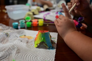 Close up view of child's hands painting