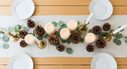 Table arrangement with plates candles pinecones eucalyptus and vintage candlesticks on a lightcolored runner
