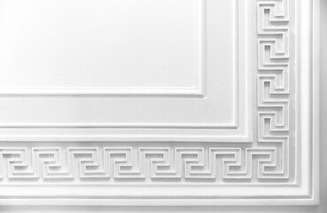 Meander motif over white wall backdrop. Classic moulding pattern,