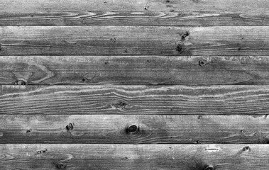 Rustic wooden planks arranged horizontally showcasing natural grains, grayscale