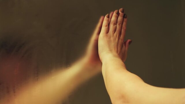 A woman's hand wipes a fogged up bathroom mirror after a hot shower to see her reflection. High quality 4k footage