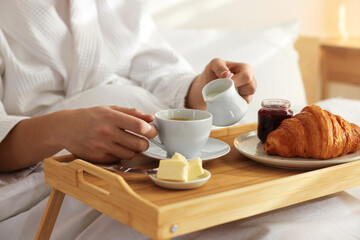 Man having delicious breakfast in bed, closeup. Hotel room service