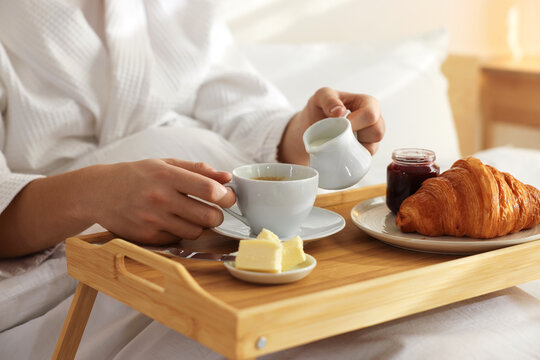 Man having delicious breakfast in bed, closeup. Hotel room service