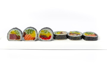 Sushi roll mix on a white dish on a white background isolated