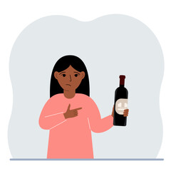 A little girl holds a bottle of wine in her hand. The concept of alcohol abuse, alcohol addiction by minors.
