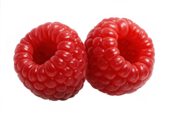 Two vibrant red raspberries, offering sweet and healthy fruit options for a balanced diet. Isolated on a transparent background