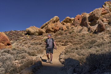 Fototapeta premium Hiker on volcanic trail in Teide National Park