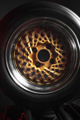 old retro stylish wheels collapsible two-component with a gold center and shiny rims for car tuning long exposure photo to simulate movement