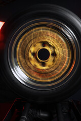 old retro stylish wheels collapsible two-component with a gold center and shiny rims for car tuning long exposure photo to simulate movement