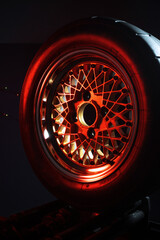 old retro stylish wheels collapsible two-component with a gold center and shiny rims for car tuning long exposure photo to simulate movement